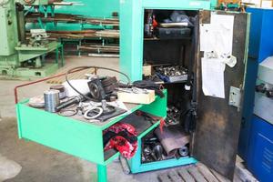 Spare parts, ring gaskets, bolts and tools on the table in the workshop at the metallurgical plant in the repair industry photo