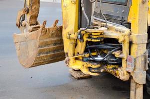 Large iron metal industrial heavy bucket of excavator, bulldozer, specialized construction equipment for road repair and excavation of the earth photo