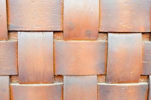 The texture of wooden unusual brown intertwined boards, pieces of wood with an overlapping cross pattern. The background photo