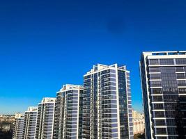 View of the new beautiful residential complex from new buildings with buildings houses monolithic concrete frame panel multi-story skyscrapers of the big city of the metropolis photo