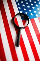 US flag looking through a magnifying glass. Study of the history and culture of the country of the United States. The concept of studying geography, English and customs photo