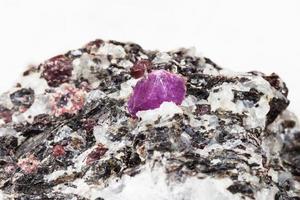 corundum crystal in gneiss stone close up on white photo