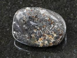 polished magnetite stone on dark background photo