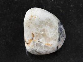 tumbled baryte stone on dark background photo