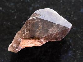 crystal of smoky quartz gemstone on dark photo