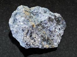 rough galena stone with chalcopyrite vein on dark photo