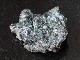 Molybdenite in Glaucophane stone on dark photo
