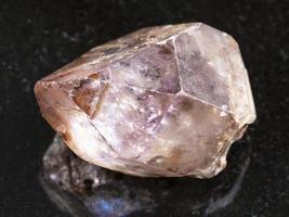 amethyst rough crystal on dark background photo