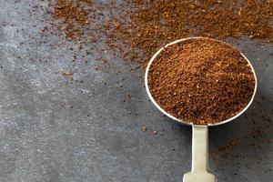 Ground Cloves Spice Spilled from a Teaspoon photo