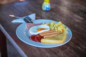 Close up Breakfast on the wooden table.fired egg ham and fired rice the easy breakfast in the morning. photo