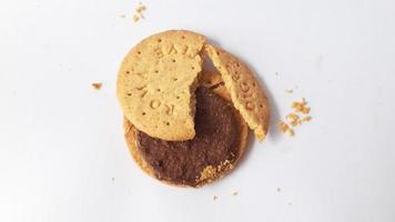 A stack of delicious wheat round biscuits with chocolate filling isolated on white background photo