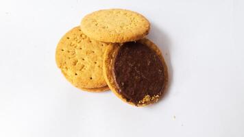 A stack of delicious wheat round biscuits with chocolate filling isolated on white background photo