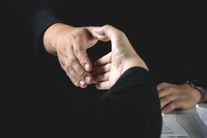 businessman and job seeker shake hands after agreeing to accept job and approve him employee at company. or joint venture agreement between two business. Concept of recruitment, successful negotiation photo