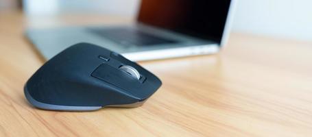 Ergonomic vertical mouse with laptop computer on adjustable desk at workplace, prevention wrist pain. De Quervain s tenosynovitis, Intersection Symptom, Carpal Tunnel or Office syndrome concept photo