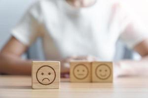 unhappy angry face from Emotion block. customer review, bad experience, negative feedback, satisfaction, survey, rating service, assessment, mood, world mental health day concept photo