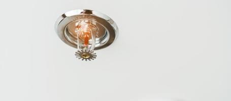 Fire Sprinkler detector mounted on roof in home or apartment. Safety and conflagration security concept photo