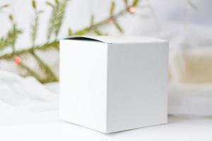 White gift box, box template, layout on a light background with a twig, if. Selective focus. the concept of Christmas and New Year. photo