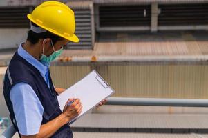 Engineers write industrial factory inspection reports.