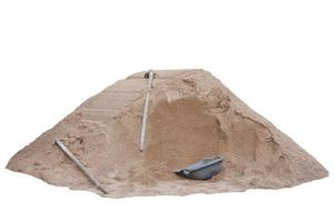 Pile of soil, clam-shell shaped basket and hoe in construction site isolated on white background included clipping path. photo