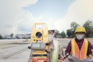 Supervisor survey engineer using surveyor equipment tacheometer and theodolite measurement checking level excavation depth of foundation at construction field. photo