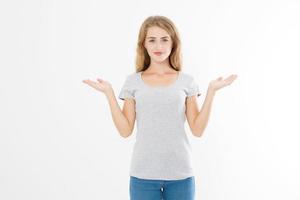 Portrait of smiling young blonde caucasian woman wearing summer t shirt pointing at copy space by hands isolated on white template and blank background. Advertising place photo