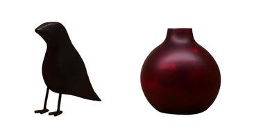 Black wooden crow bird and red or brown jug or vase isolated on white background with clipping path and make selection. Vintage or retro object for decoration home or house. Art statue. photo