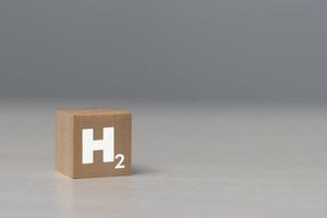 wood cube block hydrogen on table. photo