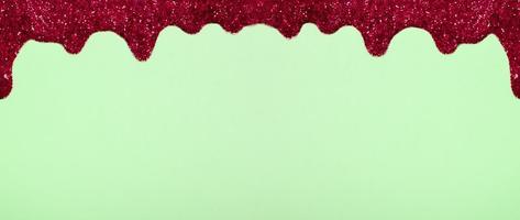 Banner with shiny border made of glitter gel on a colored background. Christmas background with copy space photo