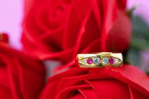 Close up wedding ring and red rose photo