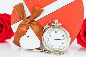 Close up pocket watch and red roses flower photo