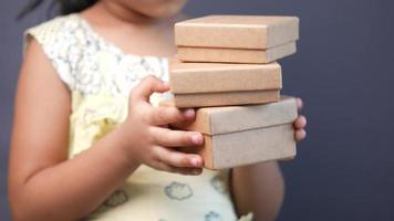 Young girl holds a stack of gift boxes video