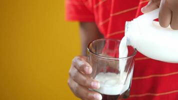 Pouring milk from liter into glass video