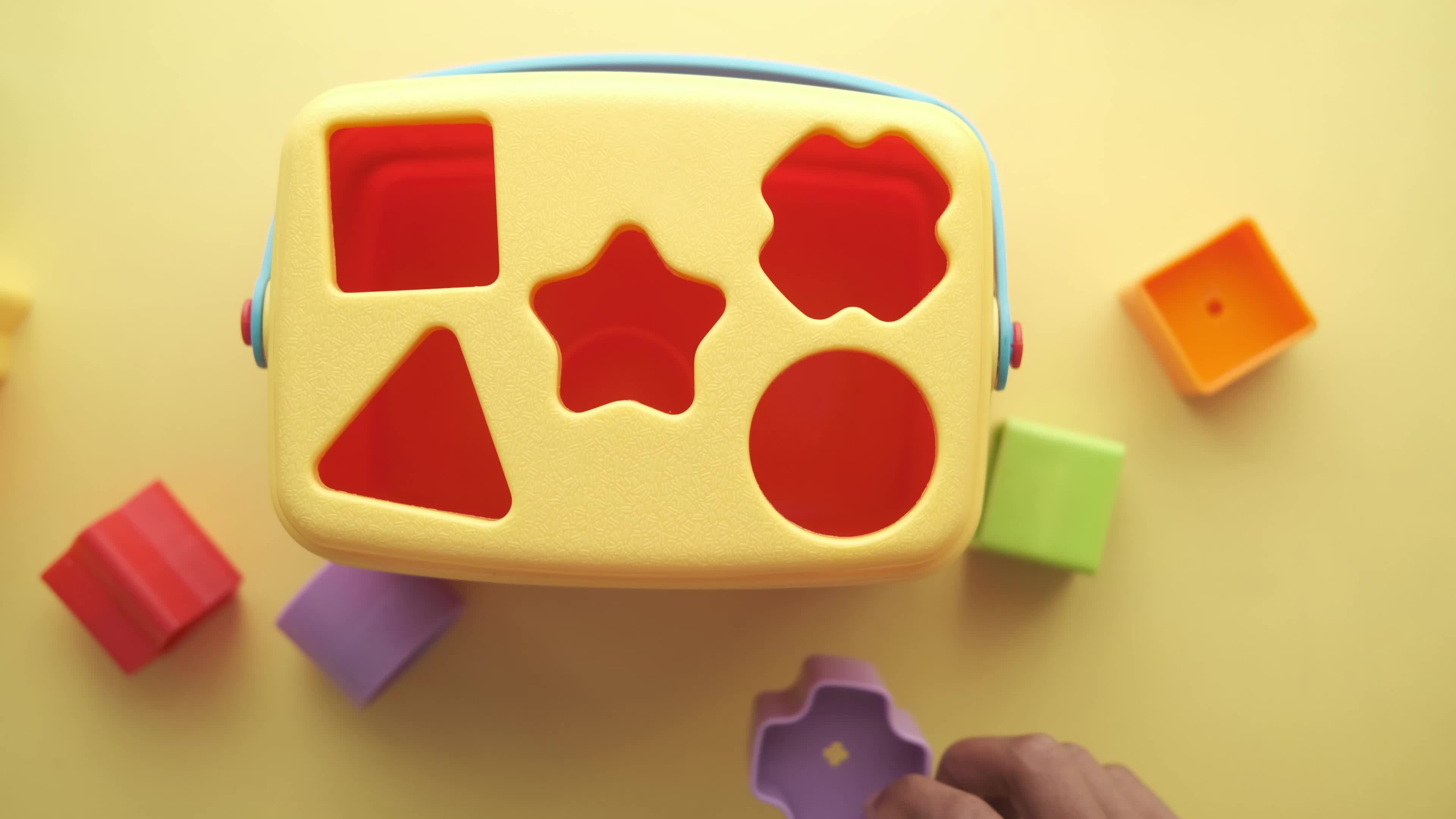 Child putting shaped blocks in appropriate holes 14179242 Stock Video