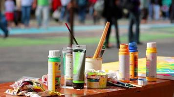 Artists painting material outside video