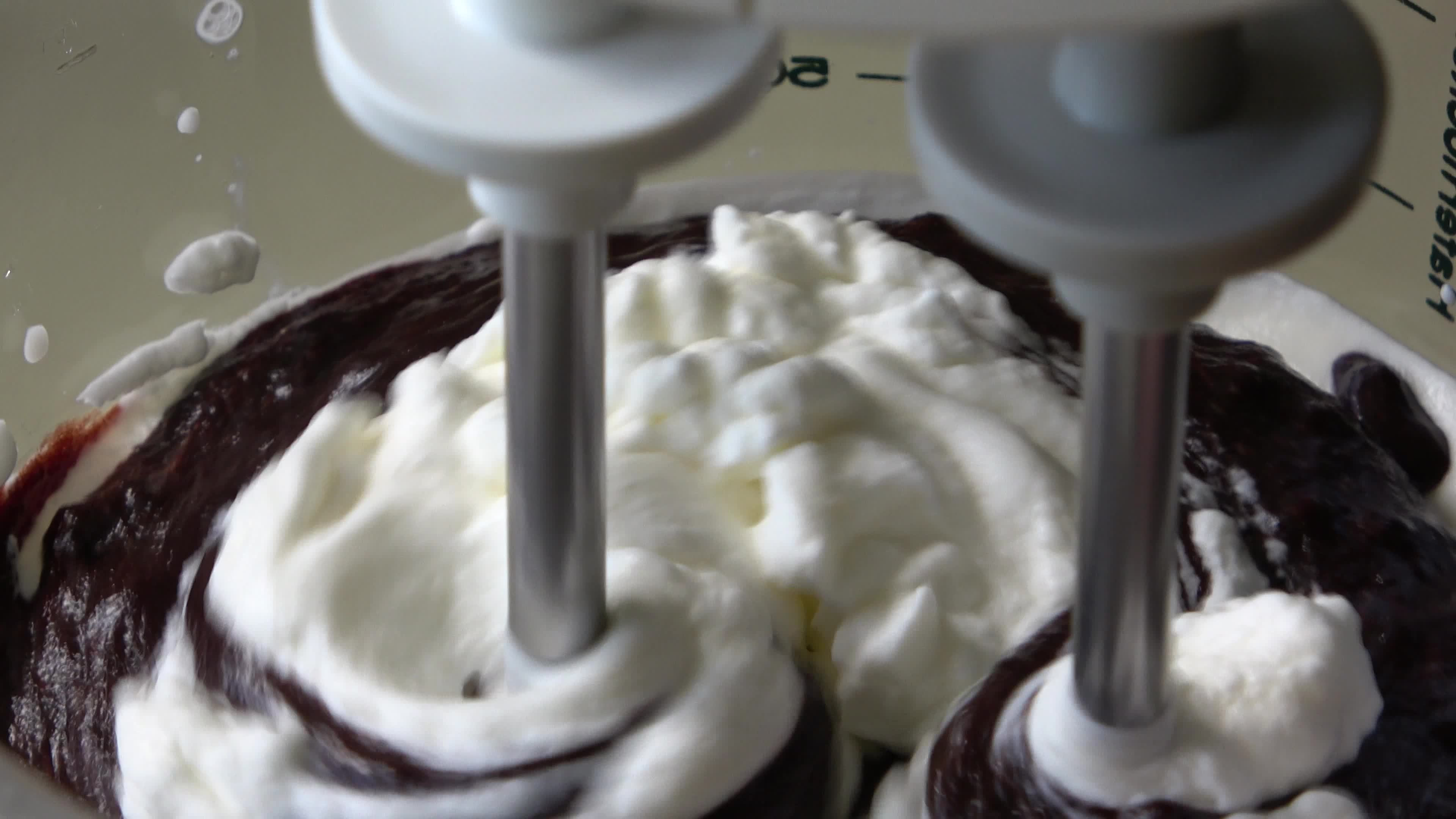 Close up of a mixer doing whipped cream 14179800 Stock Video at Vecteezy