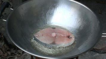 Pescado frito en una sartén, caballa española en aceite caliente, macro de vídeo de lapso de tiempo acelerado