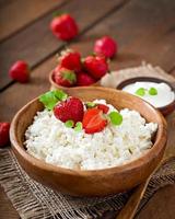 Cottage cheese with strawberries in a wooden bowl photo