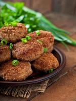 Juicy delicious meat cutlets on a wooden table in a rustic style. photo