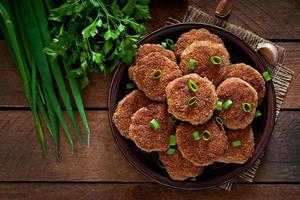 Juicy delicious meat cutlets on a wooden table in a rustic style. photo