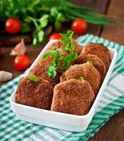 Juicy delicious meat cutlets on a wooden table in a rustic style. photo