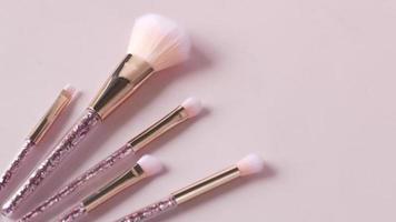 Luxury makeup brushes on pastel background video