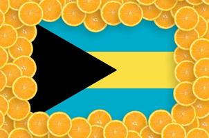 Bahamas flag  in fresh citrus fruit slices frame photo