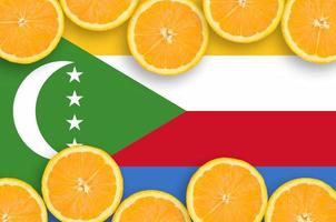 Comoros flag  in citrus fruit slices horizontal frame photo