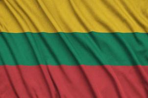 Lithuania flag  is depicted on a sports cloth fabric with many folds. Sport team banner photo