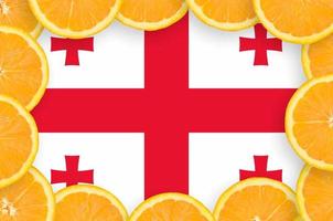 Georgia flag  in fresh citrus fruit slices frame photo