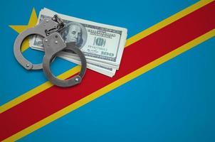 Democratic Republic of the Congo flag  with handcuffs and a bundle of dollars. The concept of breaking the law and thieves crimes photo