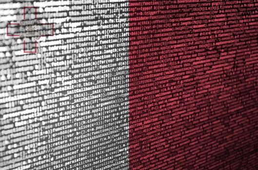 Malta flag  is depicted on the screen with the program code. The concept of modern technology and site development photo