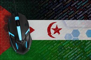 Western Sahara flag  and computer mouse. Digital threat, illegal actions on the Internet photo