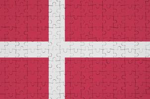 Denmark flag  is depicted on a folded puzzle photo