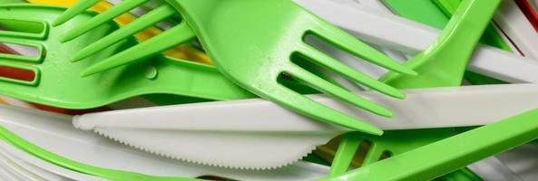 Pile of bright yellow, green and white used plastic kitchenware appliances photo